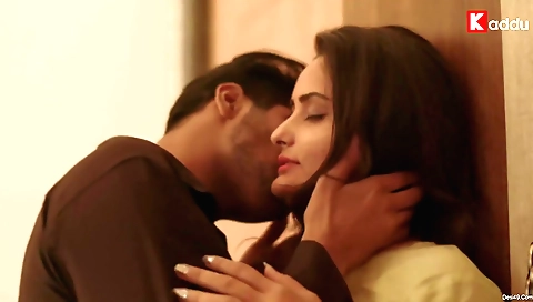 Brunette babe in an all-black dress is wearing a big black bob