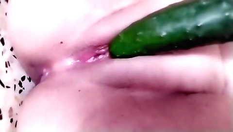 Busty babe is seducing herself with a dildo in bed