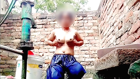 Indian brunette gets her body bathed and naked outdoors